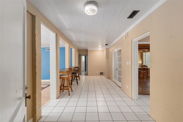 hallway with visible vents and light tile patterned floors