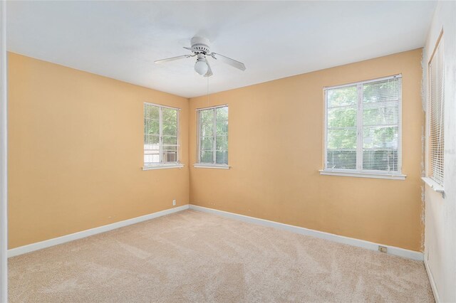 spare room featuring carpet flooring, a ceiling fan, and baseboards