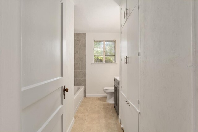 bathroom featuring vanity, baseboards, tile patterned flooring, and toilet