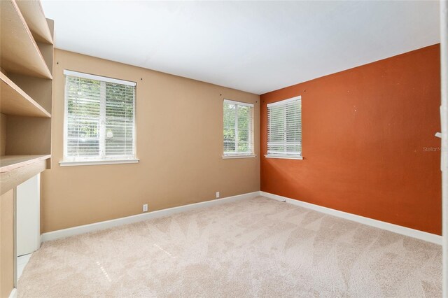 carpeted spare room with baseboards