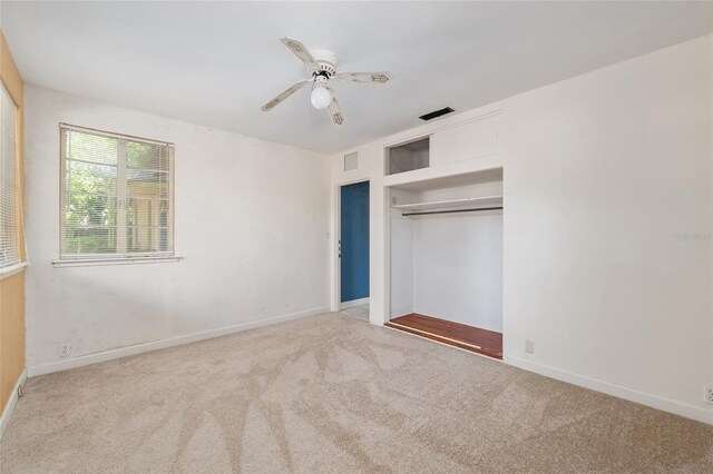 unfurnished bedroom featuring carpet flooring, baseboards, visible vents, and a closet