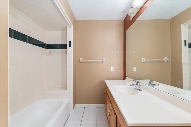 bathroom with tile patterned flooring, baseboards, bathtub / shower combination, and vanity