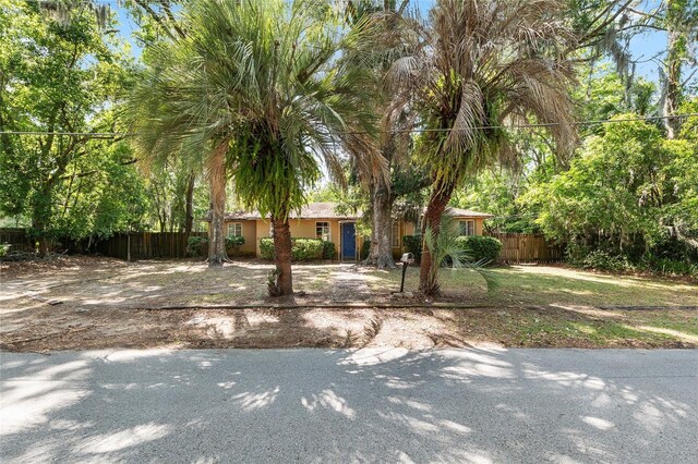 ranch-style house featuring fence