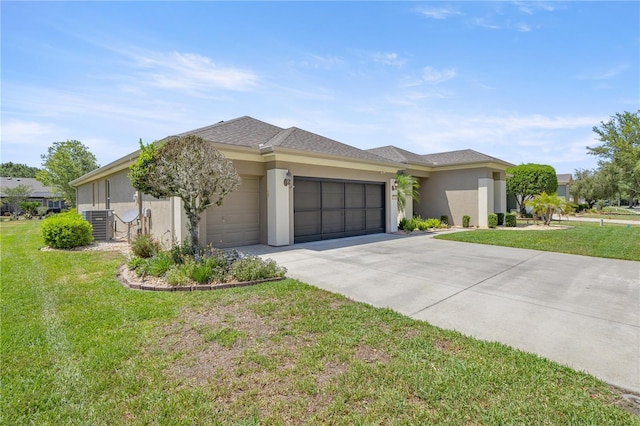 7274 SW 95th Ave, Ocala, FL 34481 - view of front of home featuring a front lawn, stucco siding, central AC unit, an attached garage, and driveway