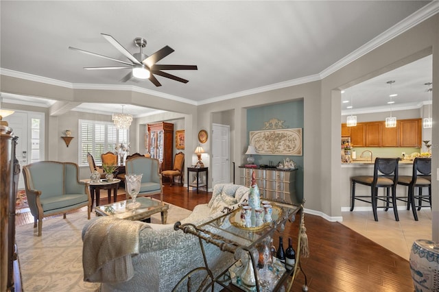 7274 SW 95th Ave, Ocala, FL 34481 - living room with crown molding, baseboards, ceiling fan with notable chandelier, and hardwood / wood-style floors