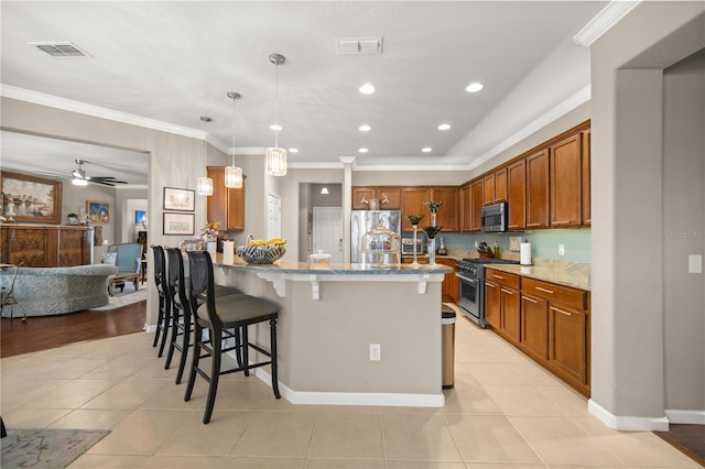 7274 SW 95th Ave, Ocala, FL 34481 - kitchen with a kitchen breakfast bar, visible vents, light stone counters, a peninsula, and stainless steel appliances