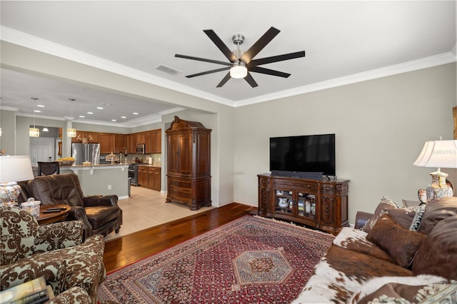 7274 SW 95th Ave, Ocala, FL 34481 - living area with visible vents, ornamental molding, recessed lighting, a ceiling fan, and light wood-style flooring