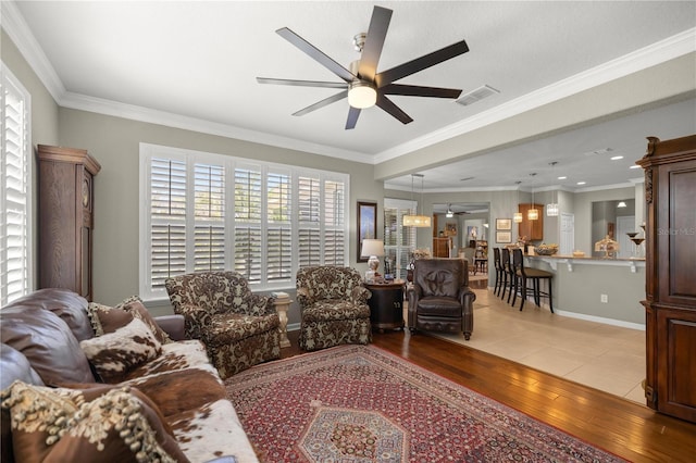 7274 SW 95th Ave, Ocala, FL 34481 - living room with crown molding, light wood-style flooring, and ceiling fan