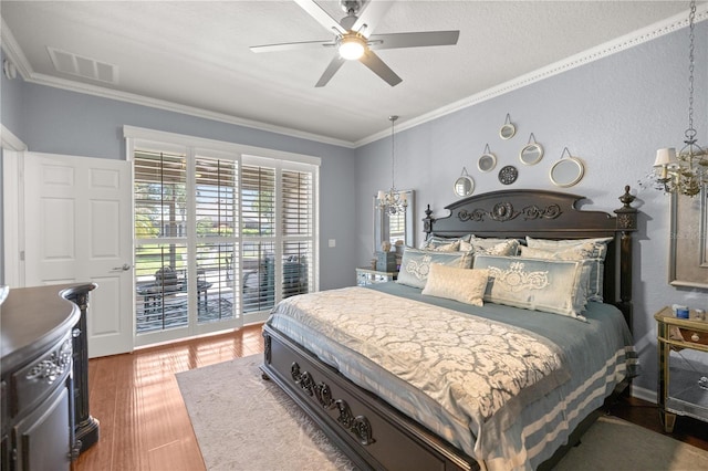 7274 SW 95th Ave, Ocala, FL 34481 - bedroom with crown molding, access to exterior, ceiling fan with notable chandelier, wood finished floors, and visible vents