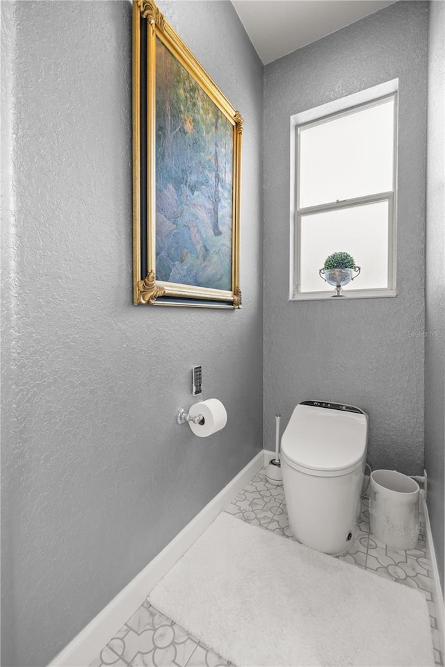 7274 SW 95th Ave, Ocala, FL 34481 - bathroom with baseboards, a textured wall, toilet, and marble finish floor