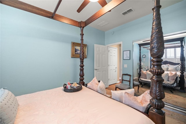 7274 SW 95th Ave, Ocala, FL 34481 - bedroom with lofted ceiling with beams, a ceiling fan, wood finished floors, and visible vents