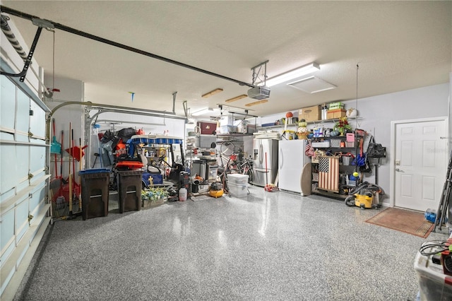 7274 SW 95th Ave, Ocala, FL 34481 - garage featuring stainless steel fridge, a garage door opener, and freestanding refrigerator