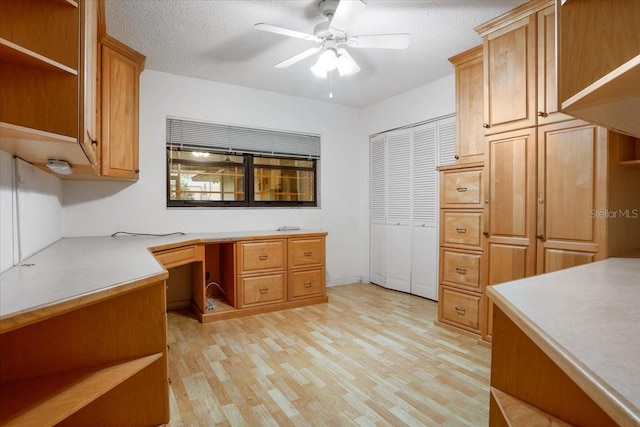 3925 NW 35th Pl, Gainesville, FL 32606 - office with built in study area, ceiling fan, light wood-type flooring, and a textured ceiling