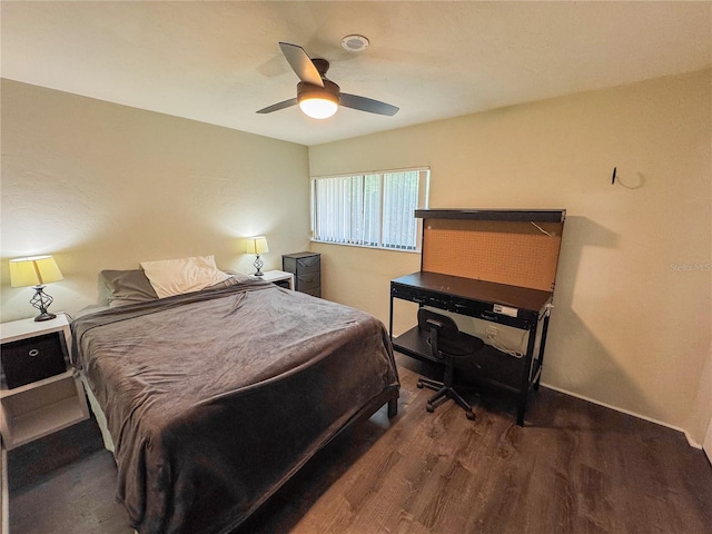 bedroom with baseboards, ceiling fan, and wood finished floors