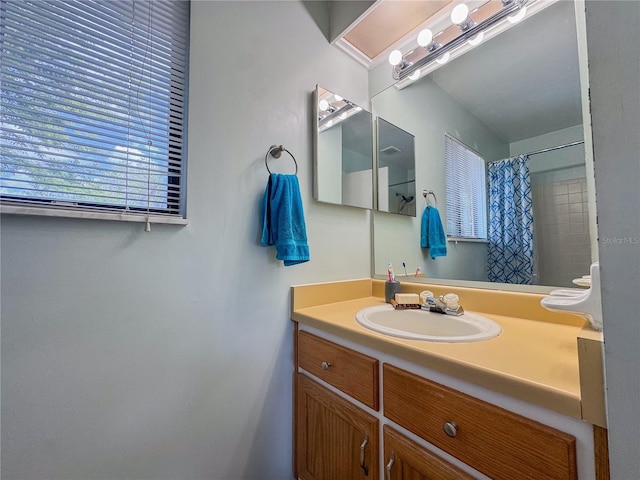 full bath with vanity and a shower with shower curtain