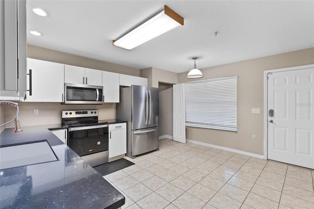 4586 SW 48th Way Unit 106, Gainesville, FL 32608 - kitchen featuring white cabinets, a sink, stainless steel appliances, baseboards, and pendant lighting