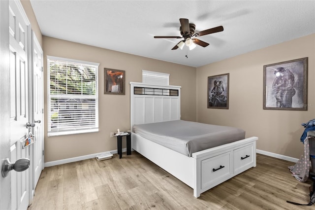 4586 SW 48th Way Unit 106, Gainesville, FL 32608 - bedroom with baseboards, ceiling fan, and light wood-style floors
