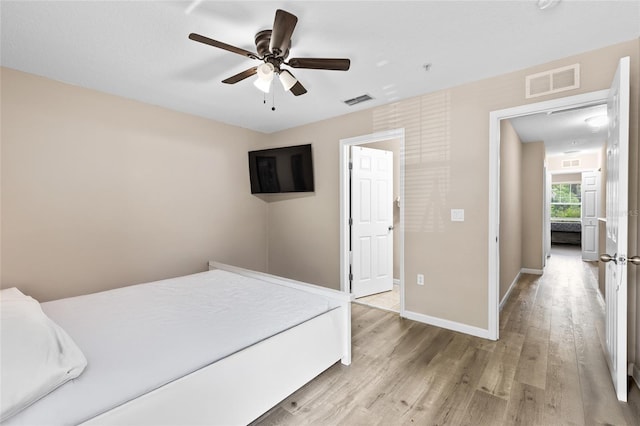 4586 SW 48th Way Unit 106, Gainesville, FL 32608 - unfurnished bedroom featuring baseboards, visible vents, and wood finished floors