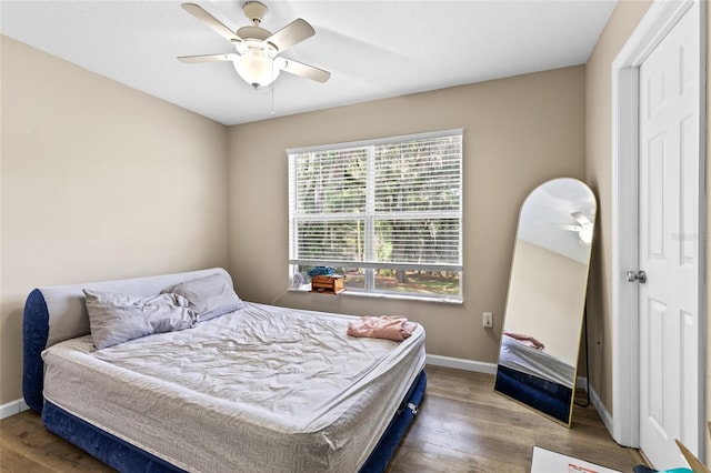 4586 SW 48th Way Unit 106, Gainesville, FL 32608 - bedroom featuring baseboards, ceiling fan, and wood finished floors