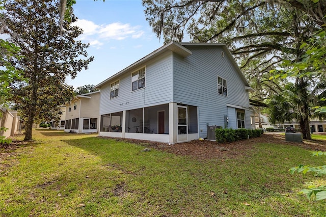 4586 SW 48th Way Unit 106, Gainesville, FL 32608 - back of house featuring a lawn and a sunroom