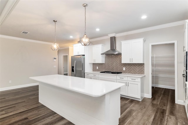 kitchen featuring stainless steel refrigerator with ice dispenser, a center island, dark wood finished floors, light countertops, and wall chimney exhaust hood