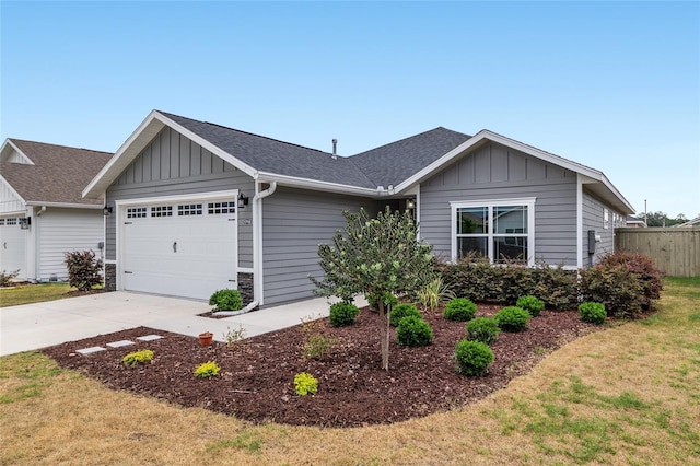 ranch-style home featuring board and batten siding, fence, driveway, and a garage