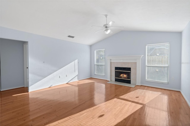 1017 NW 87th Way, Gainesville, FL 32606 - unfurnished living room featuring ceiling fan, wood finished floors, lofted ceiling, and a fireplace