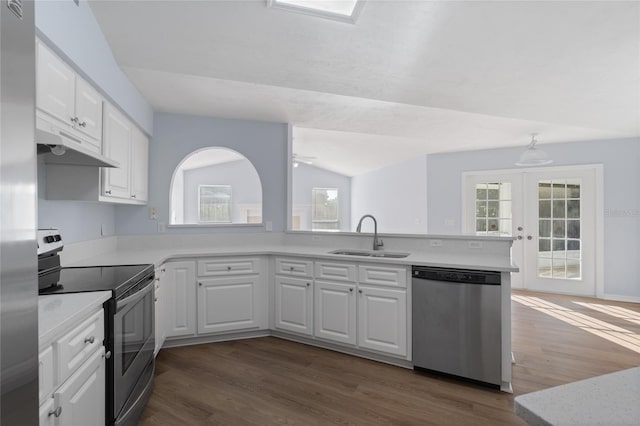 1017 NW 87th Way, Gainesville, FL 32606 - kitchen with light countertops, under cabinet range hood, a sink, dark wood finished floors, and stainless steel appliances