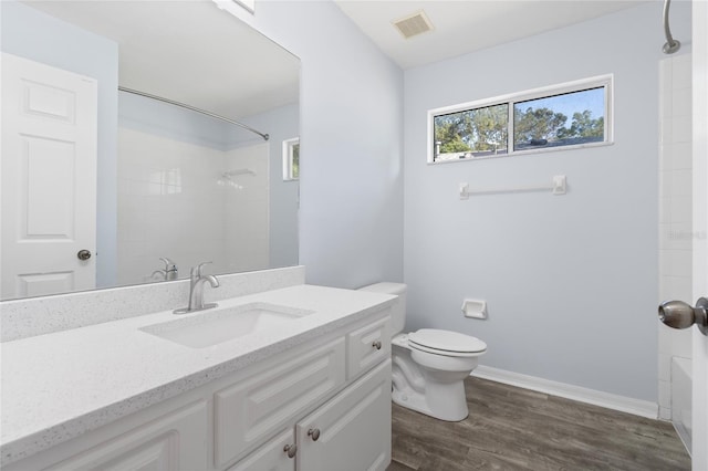 1017 NW 87th Way, Gainesville, FL 32606 - full bathroom with visible vents, vanity, wood finished floors, toilet, and baseboards