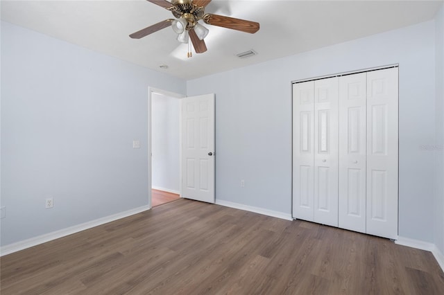 1017 NW 87th Way, Gainesville, FL 32606 - unfurnished bedroom featuring baseboards, visible vents, wood finished floors, and a closet