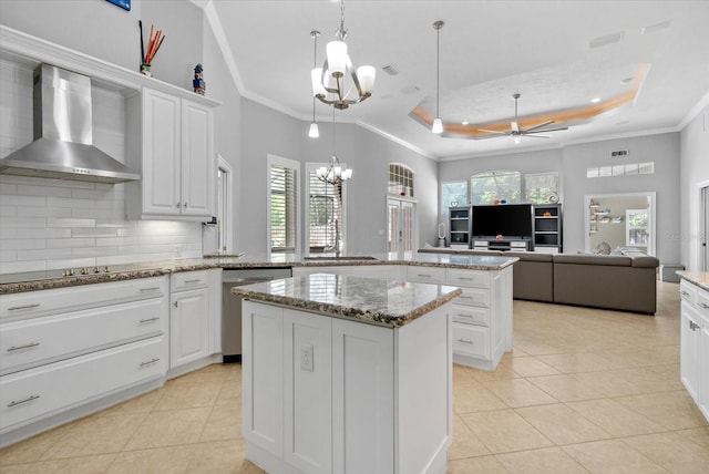 8815 SW 11th Ave, Gainesville, FL 32607 - kitchen featuring stainless steel dishwasher, wall chimney range hood, a center island, a raised ceiling, and tasteful backsplash