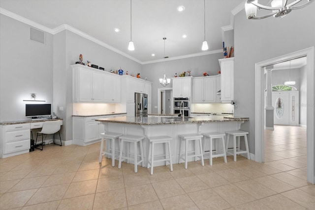 8815 SW 11th Ave, Gainesville, FL 32607 - kitchen with visible vents, a peninsula, a chandelier, appliances with stainless steel finishes, and light tile patterned floors