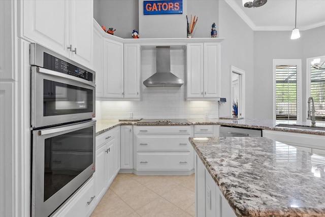 8815 SW 11th Ave, Gainesville, FL 32607 - kitchen featuring crown molding, appliances with stainless steel finishes, a sink, wall chimney exhaust hood, and white cabinetry