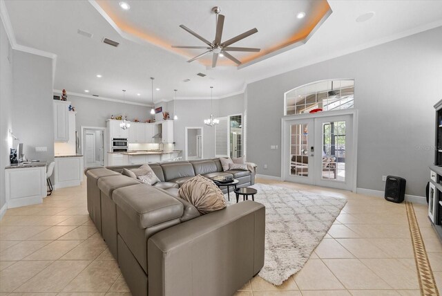 8815 SW 11th Ave, Gainesville, FL 32607 - living area with light tile patterned flooring, a raised ceiling, french doors, ceiling fan with notable chandelier, and visible vents