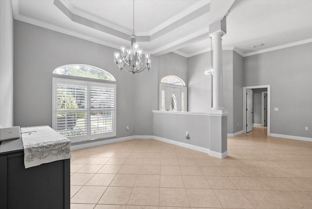 8815 SW 11th Ave, Gainesville, FL 32607 - unfurnished dining area with decorative columns, light tile patterned floors, baseboards, an inviting chandelier, and a high ceiling