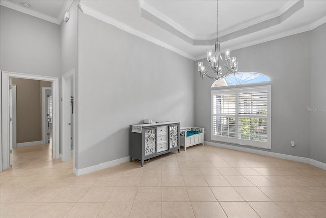8815 SW 11th Ave, Gainesville, FL 32607 - unfurnished dining area featuring ornamental molding, light tile patterned floors, a high ceiling, and a chandelier