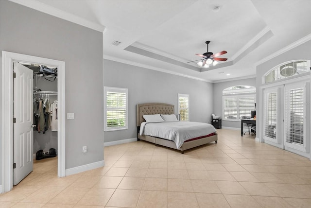 8815 SW 11th Ave, Gainesville, FL 32607 - bedroom with crown molding, a tray ceiling, multiple windows, and a walk in closet