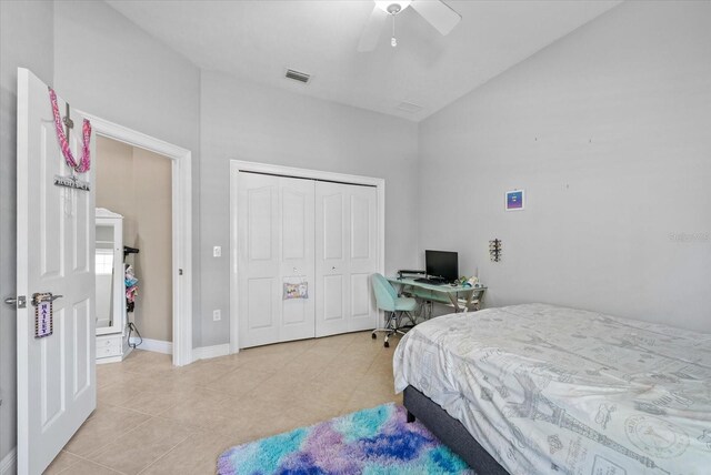 8815 SW 11th Ave, Gainesville, FL 32607 - bedroom featuring a closet, visible vents, lofted ceiling, ceiling fan, and light tile patterned floors
