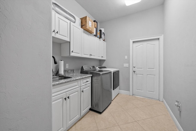 8815 SW 11th Ave, Gainesville, FL 32607 - laundry area featuring cabinet space, light tile patterned floors, baseboards, and washer and clothes dryer