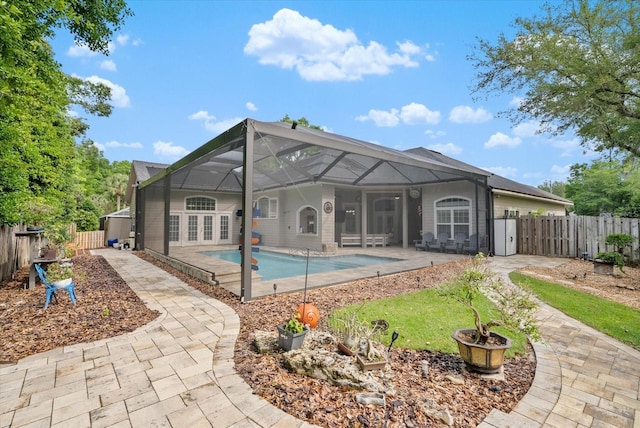 8815 SW 11th Ave, Gainesville, FL 32607 - back of property with a fenced in pool, a fenced backyard, a patio area, and a lanai