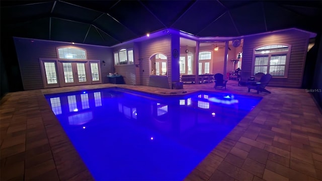 8815 SW 11th Ave, Gainesville, FL 32607 - pool at twilight featuring french doors, an outdoor pool, and a patio area