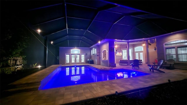 8815 SW 11th Ave, Gainesville, FL 32607 - pool at night featuring french doors, a patio area, and an outdoor pool