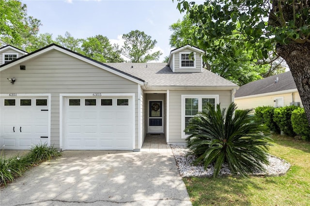 6355 NW 106th Pl, Alachua, FL 32615 - view of front of property featuring concrete driveway, an attached garage, and roof with shingles