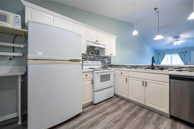 6355 NW 106th Pl, Alachua, FL 32615 - kitchen featuring decorative backsplash, under cabinet range hood, white appliances, and lofted ceiling