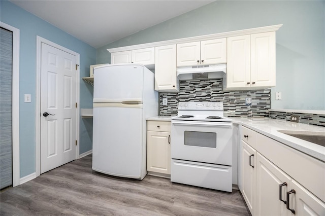 6355 NW 106th Pl, Alachua, FL 32615 - kitchen featuring lofted ceiling, white appliances, white cabinetry, under cabinet range hood, and backsplash