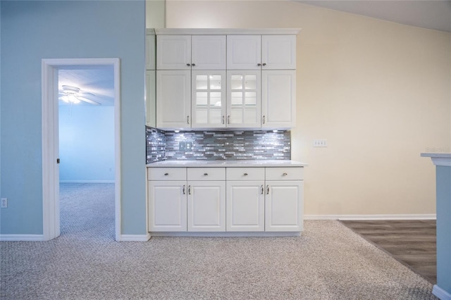 6355 NW 106th Pl, Alachua, FL 32615 - kitchen featuring light countertops, decorative backsplash, white cabinets, and carpet flooring