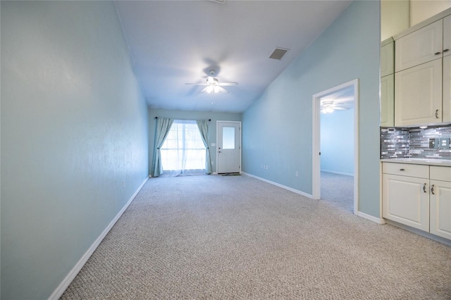 6355 NW 106th Pl, Alachua, FL 32615 - unfurnished living room with visible vents, a ceiling fan, baseboards, and light carpet