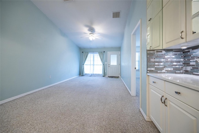 6355 NW 106th Pl, Alachua, FL 32615 - kitchen featuring ceiling fan, light carpet, baseboards, decorative backsplash, and visible vents