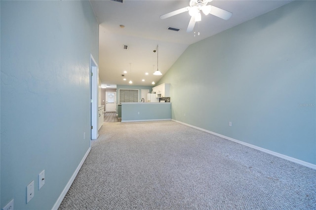 6355 NW 106th Pl, Alachua, FL 32615 - unfurnished living room with ceiling fan, light colored carpet, visible vents, baseboards, and vaulted ceiling