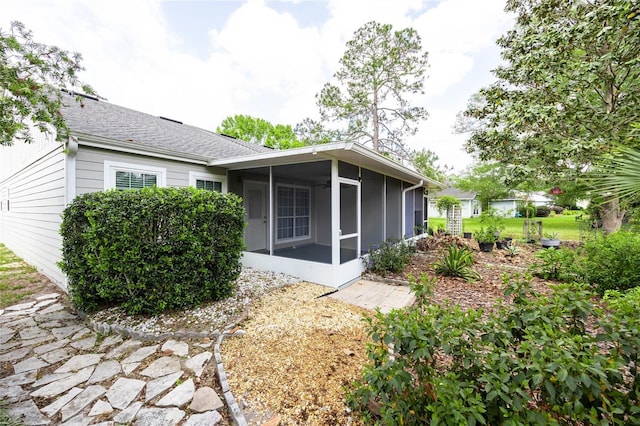 6355 NW 106th Pl, Alachua, FL 32615 - rear view of house featuring a sunroom and a shingled roof